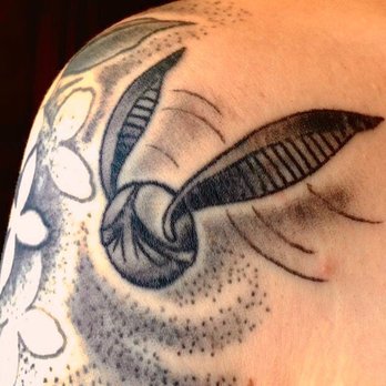 Iron Age Studios - Snitch by Caleb Quales, flowers in the background by Jason Bane - Tattoo Near Me - Saint Louis, Missouri