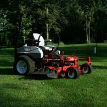 Ultimate Lawns - a man mowing the grass - Landscaping Near Me Ultimate Lawns - a man mowing the grass - Landscaping Near Me
