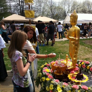 Wat Thai DC Buddhist Temple - Pouring water onto the Buddha statue to pay respect and cleanse the statue and your soul. Like a spring cleaning. - Buddhist Temples Near Me - Silver Spring, Maryland