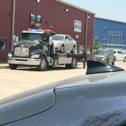 Alamo Car Center - June 21, 2023 - the Chevy Impala being towed off the repair shop lot because it does not start.