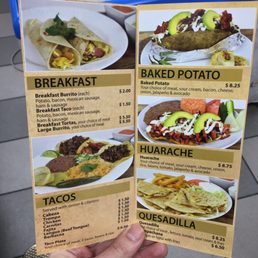 a hand holding a menu a hand holding a menu