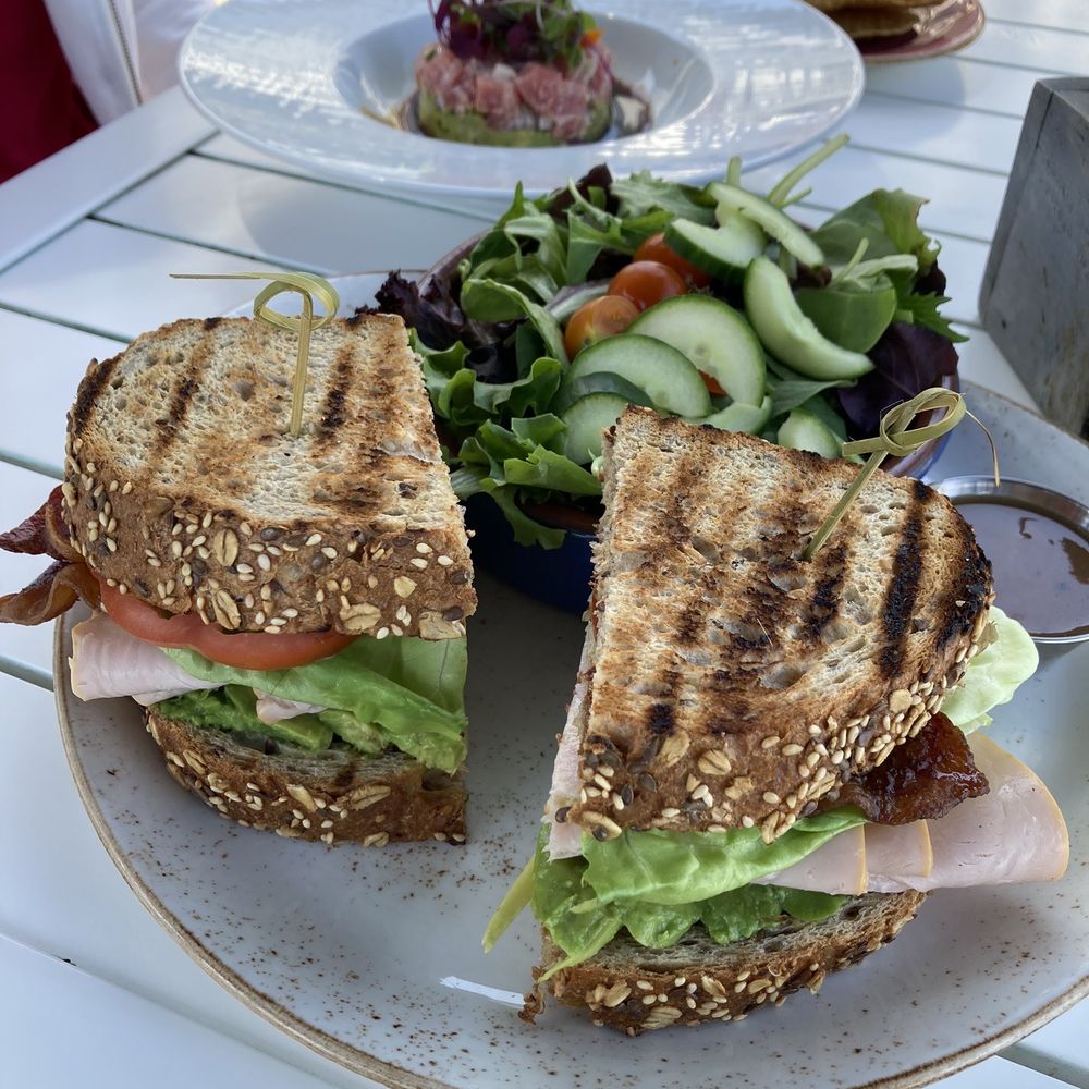 ALBACA - Turkey BLT in the foreground with the pokey in the background. - New American Near Me - Coronado, California ALBACA - Turkey BLT in the foreground with the pokey in the background. - New American Near Me - Coronado, California
