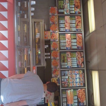 Crown Fried Chicken - a man standing in front of a vending machine - Fast Food Near Me - Bronx, New York