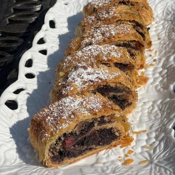 Saya Bakery - a pastry on a white plate - Desserts Near Me Saya Bakery - a pastry on a white plate - Desserts Near Me