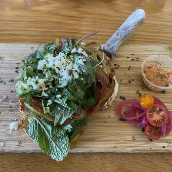 Outpost Kitchen - Avocado toast with "Asian" greens and millionaire bacon.   Pickled onion, tomato and red pepper pesto (spicy) requested on the side. - Breakfast & Brunch Near Me - Costa Mesa, California