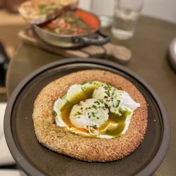 Ergon London - Poached eggs on sesame bagel "koulouri" with Greek yogurt and spicy oil
