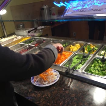 Elgin Buffet - a woman preparing food in a buffet - Buffets Near Me - Elgin, Illinois