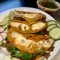 Ceyer's Taqueria - Quesabirria Tacos- 3 Panfried tortillas filled w/shredded birria beef malted mozzarella. onions, cilantro, limes, and a side of consomé!.