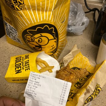 Golden Chick - a person holding a receipt and a bag of chicken nuggies - Fast Food Near Me - Austin, Texas