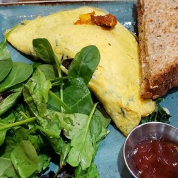 Cold omelette with a haphazard side of spinach. Poor quality.