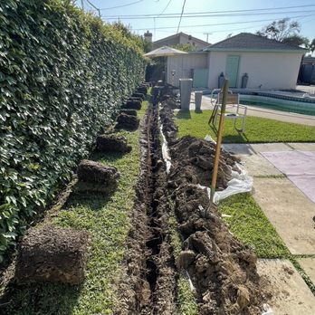 JMJP Electric - 18" deep trench with rolls of sod for the 75' span from the main panel to the new subpanel. - Electricians Near Me