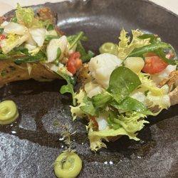 Salt cod fish salad with red onion in a whole grain tacos