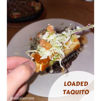Next Door - a plate of food with a hand holding a piece of food - Mexican Near Me - Long Beach, California Next Door - a plate of food with a hand holding a piece of food - Mexican Near Me - Long Beach, California