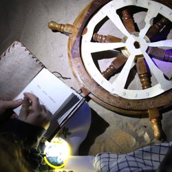 Red Herring Treasure Hunts - UV light transformed this ship's wheel into a cipher wheel.