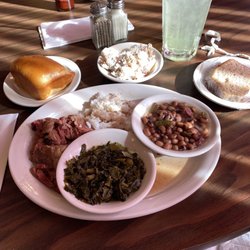 Roast beef and rice, black eyed peas, greens, fruit salad, yeast roll, sock it to me cake, lemonade