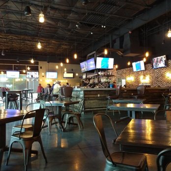 Woodson's Local Tap + Kitchen Grand Parkway - Side view from North sitting area - American Near Me - Spring, Texas Woodson's Local Tap + Kitchen Grand Parkway - Side view from North sitting area - American Near Me - Spring, Texas