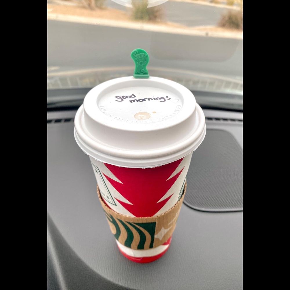 a starbucks cup on the dashboard of a car a starbucks cup on the dashboard of a car