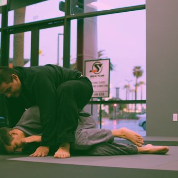 Uncharted Jiu Jitsu - Student rolling with instructor Spencer. - Martial Arts Near Me - Corona, California Uncharted Jiu Jitsu - Student rolling with instructor Spencer. - Martial Arts Near Me - Corona, California