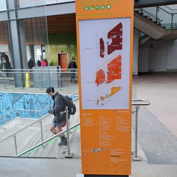 Starbucks - a man standing next to a large orange sign - Coffee & Tea Near Me - Vancouver, British Columbia Starbucks - a man standing next to a large orange sign - Coffee & Tea Near Me - Vancouver, British Columbia