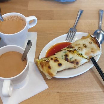 Breakfast ING - Green onion pancake with pork floss and corn, and sweet chili sauce on the side. Milk tea to the left - Breakfast & Brunch Near Me - Mississauga, Ontario Breakfast ING - Green onion pancake with pork floss and corn, and sweet chili sauce on the side. Milk tea to the left - Breakfast & Brunch Near Me - Mississauga, Ontario