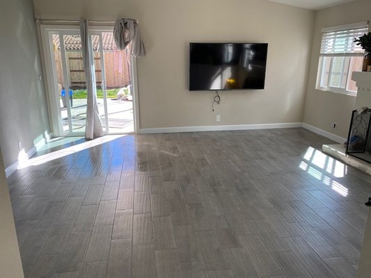 Escondido Flooring Installation - The customer had two leaks - water heater and the toilet. The restoration was already completed so we came in to demo the existing LVP flooring and baseboards. My tile installer then came in to self-level the slab and install new 6" x 24" tiles and grout. We then installed, caulk, and painted new baseboards as well as completed drywall repairs and painted the whole house corner to corner. Escondido Flooring Installation - The customer had two leaks - water heater and the toilet. The restoration was already completed so we came in to demo the existing LVP flooring and baseboards. My tile installer then came in to self-level the slab and install new 6" x 24" tiles and grout. We then installed, caulk, and painted new baseboards as well as completed drywall repairs and painted the whole house corner to corner.