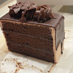 White's Bakery & Cafe - I chocolate cake slice with chocolate frosting between the thick layers of cake
