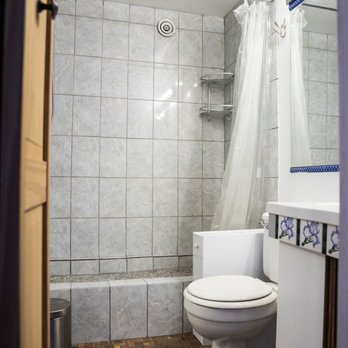 Ashyana Home Improvement - The floor of the standing shower is almost a foot higher than the floor of the bathroom, and the tiles were not water-sealed. - General Contractors Near Me - Alexandria, Virginia