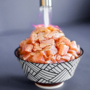 Just Poké West Seattle - a bowl of food with chopsticks - Poke Near Me - Seattle, Washington