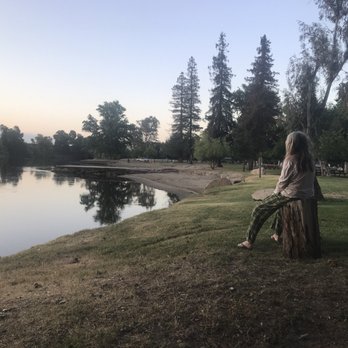 Lindy's Landing Market - a woman sitting on a stump by a lake - Grocery Near Me - Reedley, California Lindy's Landing Market - a woman sitting on a stump by a lake - Grocery Near Me - Reedley, California