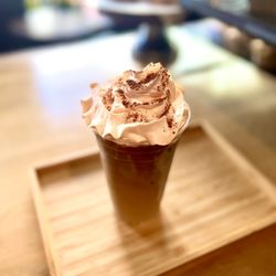The Grind House - As you requested " iced Coffee finished with whip cream and a sprinkle of Cinnamon "