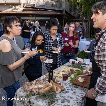 Freestone Artisan Cheese - a group of people standing around a table - Cheese Shops Near Me - Freestone, California