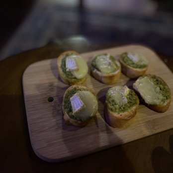 The Office - a wooden cutting board with small pieces of bread on it - Whiskey Bars Near Me - Reno, Nevada