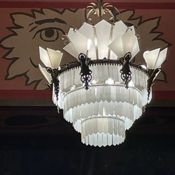 Liberty Hall - Stunning intricate hanging lamp in front of hand-painted trim work. - Performing Arts Near Me - Lawrence, Kansas