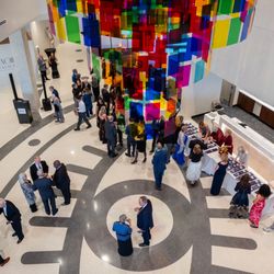 Museum of Art + Light - View looking down from the second story, featuring the atrium chandelier and the terrazzo floor.