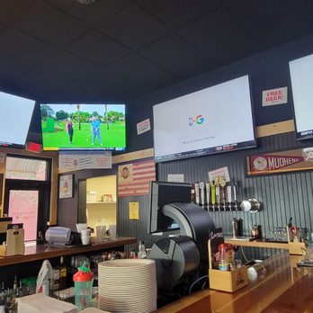 Roosters - a man sitting at a bar watching televisions - Sports Bars Near Me - Sylvania, Ohio Roosters - a man sitting at a bar watching televisions - Sports Bars Near Me - Sylvania, Ohio
