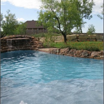 Extreme Exteriors - a pool with a waterfall - Landscaping Near Me - Abilene, Texas Extreme Exteriors - a pool with a waterfall - Landscaping Near Me - Abilene, Texas