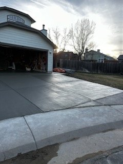 Completed Driveways - At RockSolid Turf and Landscape, our experienced and professional team takes pride in delivering high-quality driveway installations that combine durability and style. Recently, we completed two distinct driveway projects that showcase our expertise.
We completed a classic concrete driveway. After expertly preparing the site, our team poured and smoothed the concrete to create a flawless, even surface. This driveway not only offers exceptional durability and ease of maintenance but also stands out, enhancing the overall appeal of the home. Completed Driveways - At RockSolid Turf and Landscape, our experienced and professional team takes pride in delivering high-quality driveway installations that combine durability and style. Recently, we completed two distinct driveway projects that showcase our expertise.
We completed a classic concrete driveway. After expertly preparing the site, our team poured and smoothed the concrete to create a flawless, even surface. This driveway not only offers exceptional durability and ease of maintenance but also stands out, enhancing the overall appeal of the home.