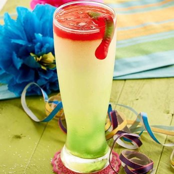 El Chico - a glass of a drink with a straw and a strawberry garnish - Mexican Near Me - Texarkana, Arkansas El Chico - a glass of a drink with a straw and a strawberry garnish - Mexican Near Me - Texarkana, Arkansas