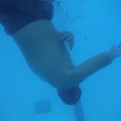 Del Cerro Pool - Underwater shot by drain in deep end. Can see blue lap lanes on floor.