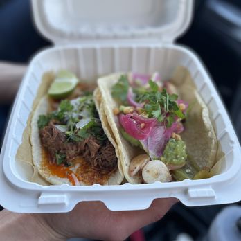 Corazon Cocina - a hand holding two tacos - Mexican Near Me - Santa Barbara, California Corazon Cocina - a hand holding two tacos - Mexican Near Me - Santa Barbara, California