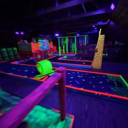 A Maze'n Farmyard - Themed Black Light mini golf.