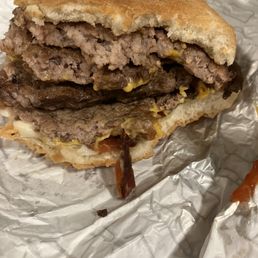 a hamburger and bacon on a piece of tin foil a hamburger and bacon on a piece of tin foil