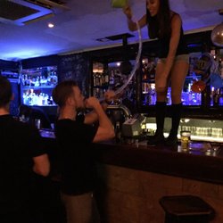 Three Monkeys - Beer bong. There's a tally scoreboard behind the bar. Canada is sixth.