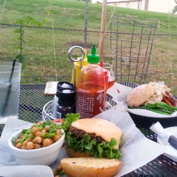 Pig Minds Brewing - On the patio surrounded by grape vines. Pig Minds Burger with a side of fried chickpeas tossed in green onions. - Brewpubs Near Me - Machesney Park, Illinois Pig Minds Brewing - On the patio surrounded by grape vines. Pig Minds Burger with a side of fried chickpeas tossed in green onions. - Brewpubs Near Me - Machesney Park, Illinois