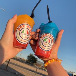 two people holding drinks