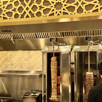 Sultan’s - a man preparing food in a kitchen - Mediterranean Near Me - Toronto, Ontario Sultan’s - a man preparing food in a kitchen - Mediterranean Near Me - Toronto, Ontario