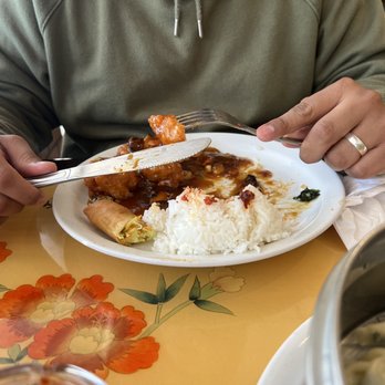 Feng Ling Restaurant - a man sitting at a table with a plate of food - Chinese Near Me - Houston, Texas