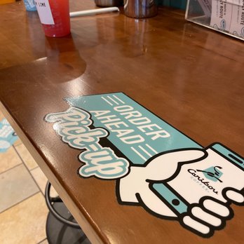 Caribou Coffee - a table with a sign on it - Coffee & Tea Near Me - Roseville, Minnesota