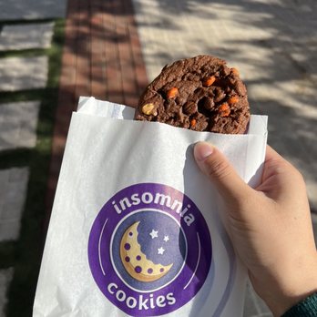 Insomnia Cookies - a hand holding a cookie - Desserts Near Me - Los Angeles, California Insomnia Cookies - a hand holding a cookie - Desserts Near Me - Los Angeles, California