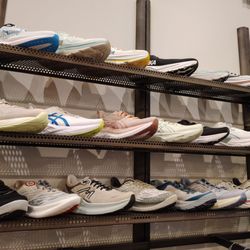 Fleet Feet - West Ashley - Wall of ladies shoes as of January 2026. There's also another display for ladies and two for men's shoes